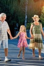 Child with grandparents walking outdoors. Royalty Free Stock Photo