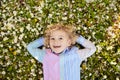 Child on green grass lawn with summer flowers Royalty Free Stock Photo