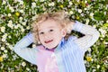 Child on green grass lawn with summer flowers Royalty Free Stock Photo