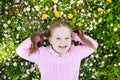 Child on green grass lawn with summer flowers Royalty Free Stock Photo