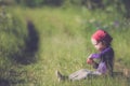 Child in green wild meadow eating wild strawberries. Summer happy times. Royalty Free Stock Photo