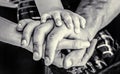 Child hand closeup into parents. Hands of father, mother, keep hand little baby. Parents hold the baby hands. Closeup of Royalty Free Stock Photo