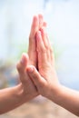 Female childÃ¢â¬â¢s hand holding the hand of elder male shot with a bokeh background and horizontal.