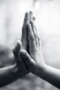 Female childÃ¢â¬â¢s hand holding the hand of elder male shot with a bokeh background and horizontal.