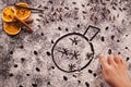 Child hand drawing christmas bauble in flour