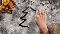 Child hand drawing a christmas tree in the flour