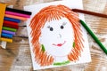 Child hand drawing Mother Portrait with wax crayons. Wooden background Royalty Free Stock Photo