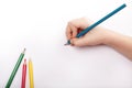 Child hand draws a blue pencil Royalty Free Stock Photo