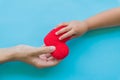 Child hand giving red heart to her dad, Royalty Free Stock Photo