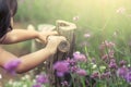 Child hand holding bamboo railing in the flower garden Royalty Free Stock Photo