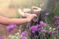 Child hand holding bamboo railing in the flower garden Royalty Free Stock Photo