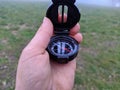 Child hand holding a compass, in a foggy day Royalty Free Stock Photo