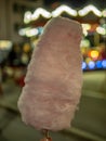 Child hand holding a cotton candy stick at a night fair in Switzerland Royalty Free Stock Photo