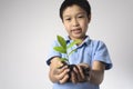 Child hand holding litter plant