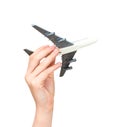 Child hand holding model airplane. Royalty Free Stock Photo