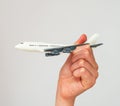 Child hand holding model airplane. Royalty Free Stock Photo