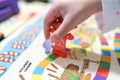 Child hand holding a red candyland game piece Royalty Free Stock Photo