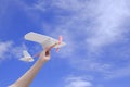 Child hand holding rubber powered aircraft up in the air Royalty Free Stock Photo