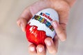 Child hand with Kinder Surprise egg