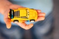 Child hand with Lego Jeff Gorvette car