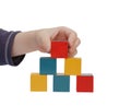 Child hand make a building of colored blocks Royalty Free Stock Photo