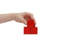 Child hand make a building with red blocks Royalty Free Stock Photo