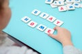 Child hand makes word STAY HOME