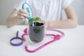 Child hand measuring temperature with thermometer. Experiment on a young plant. Caring for a new life. Climate change Royalty Free Stock Photo
