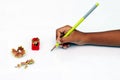 Child hand with pencil and sharpener. Royalty Free Stock Photo