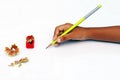 Child hand with pencil and sharpener. Royalty Free Stock Photo