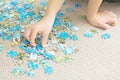 Child hand playing complex puzzle