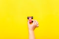 Child hand playing with wooden toy car on yellow background Royalty Free Stock Photo