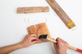 child hand with pliers and hammer on a white table