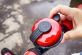 Child hand ringing bicycle bell outside.