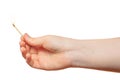 A child hand with a thin burning match on a white background. Royalty Free Stock Photo