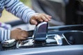 A child hand touches the gearshift knob of a modern car. close-up no face. interior of a premium car. driving learning concept