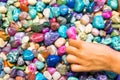 Child hand touching colourful stones Royalty Free Stock Photo