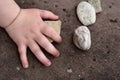 Child hand touching a stone