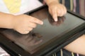 Child hand using touchscreen tablet PC closeup Royalty Free Stock Photo