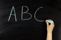 child hand writes on the blackboard abc Royalty Free Stock Photo