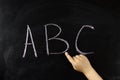 child hand writes on the blackboard abc Royalty Free Stock Photo