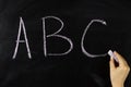 child hand writes on the blackboard abc Royalty Free Stock Photo