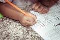 Child hand writing her homework with crayon Royalty Free Stock Photo