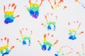 Child handprints of rainbow colors, on white sheet of paper. Top view Royalty Free Stock Photo