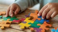 Child hands assembling colorful puzzle pieces Royalty Free Stock Photo