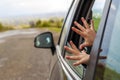 Child hands in a car window during travel to vacation Royalty Free Stock Photo