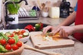 Child hands chopping vegetables on cutting board - the spring on Royalty Free Stock Photo