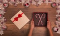 Child hands with christmas gift box containing candy canes Royalty Free Stock Photo