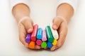 Child hands with colorful clay bars