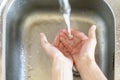 Child hands cups water pour from crane d Royalty Free Stock Photo